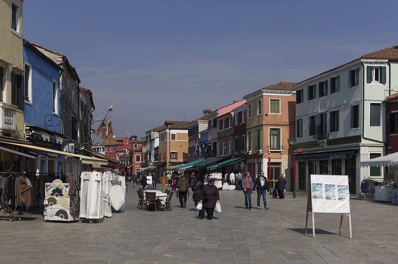 A wide street on Burano leading to San Martino's bell tower