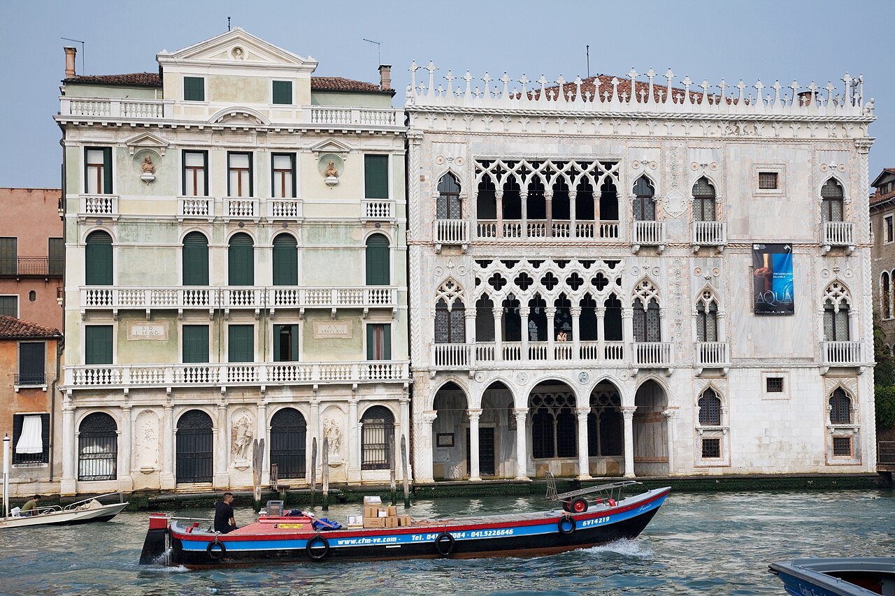 The Ca' d'Oro beside its neighbor, a boat passing below