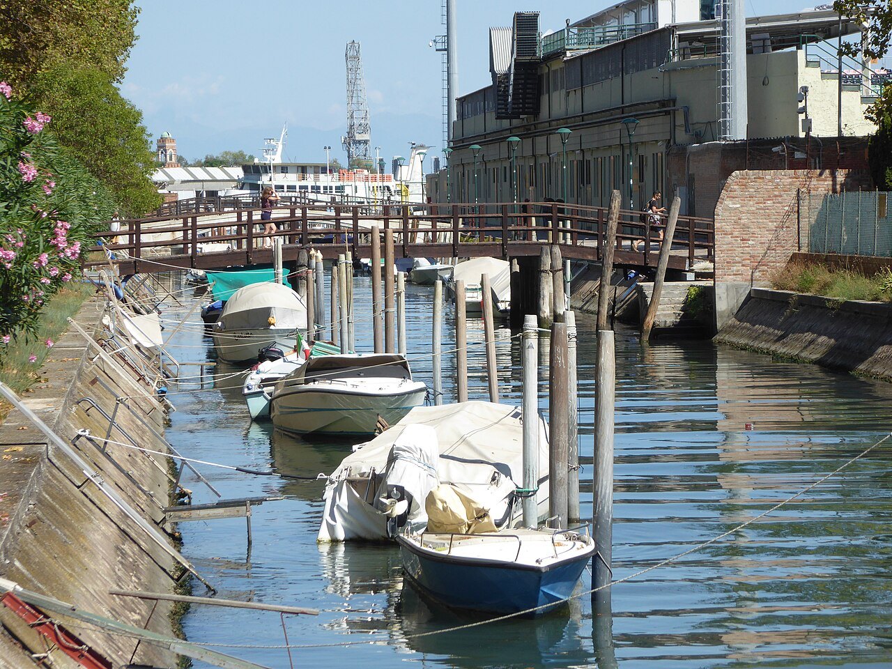 Boats moored in the Rio di Sant'Elena by a wooden bridge