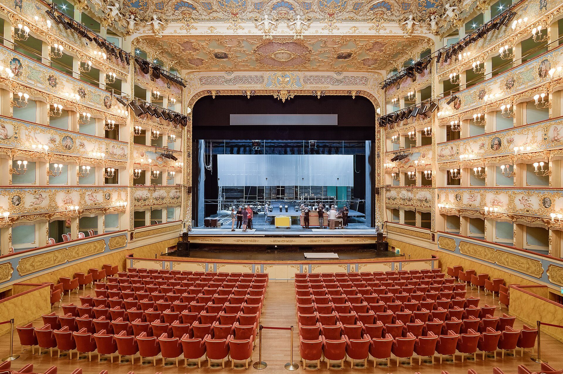 The auditorium of La Fenice, the stage lit beyond the red stalls