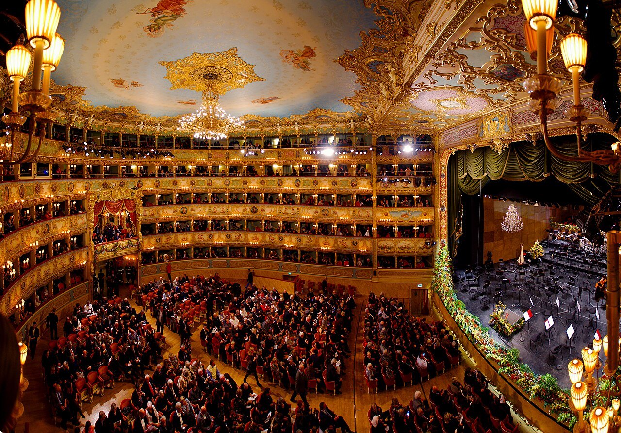 La Fenice full for a performance, its tiers of boxes gilded