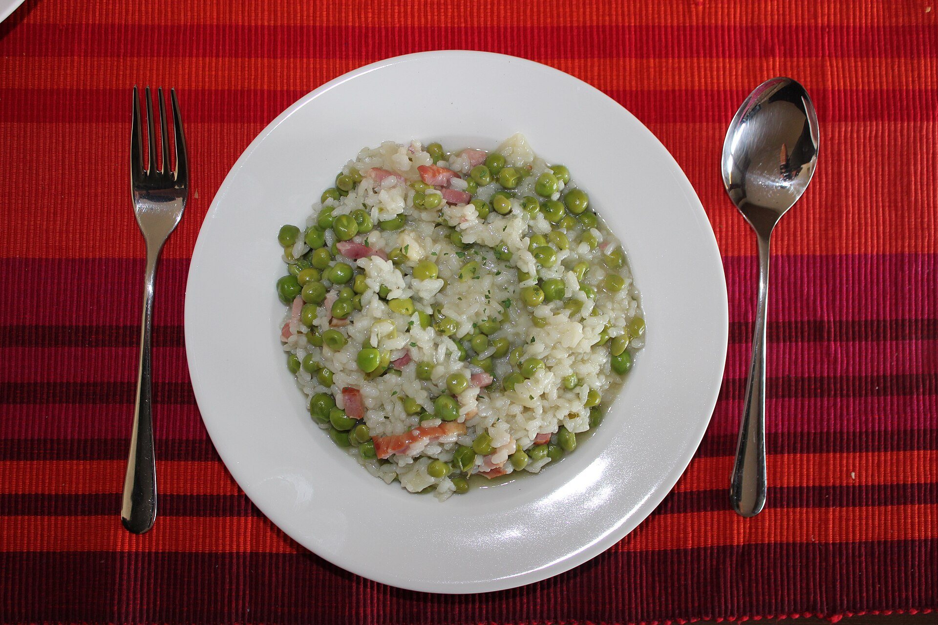 Risi e bisi, rice and peas, on a red tablecloth