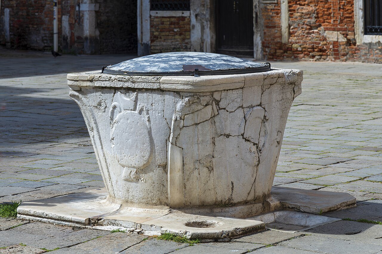 A worn stone wellhead in Campo San Silvestro