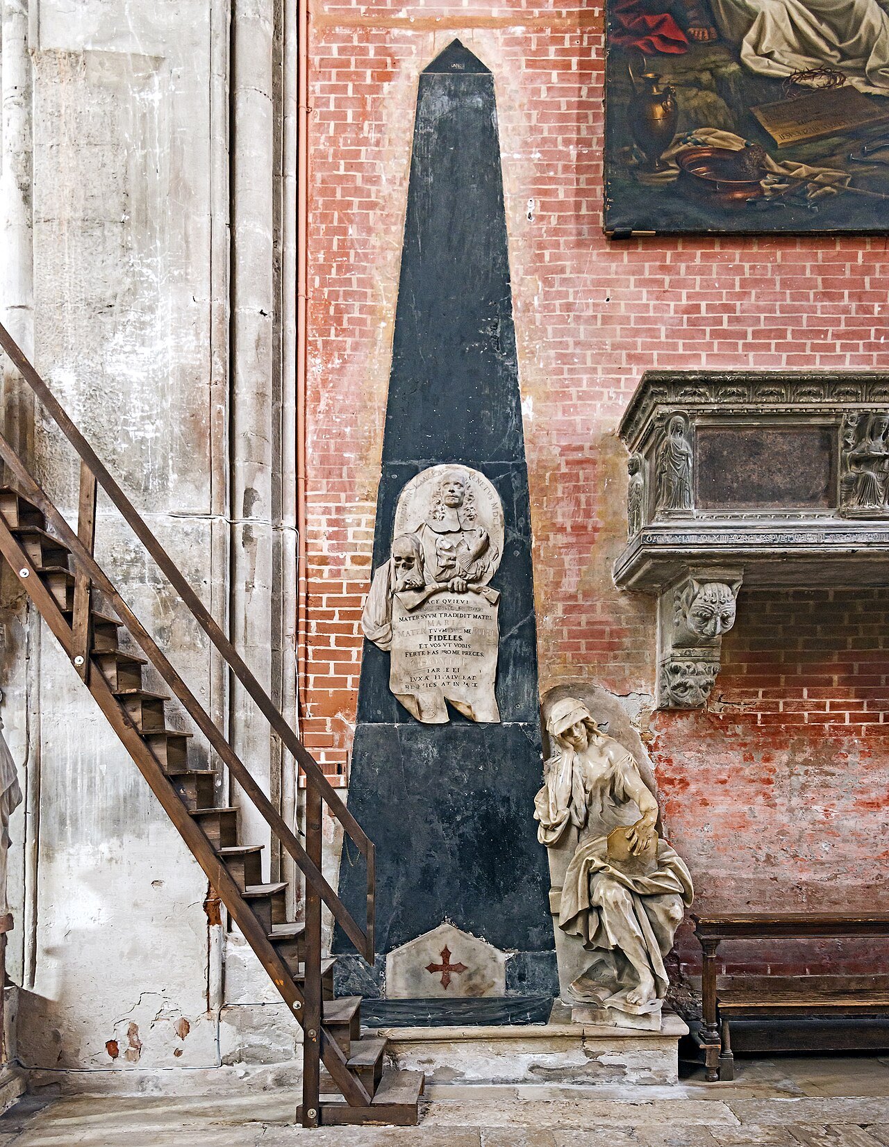 A tomb monument with an obelisk in a chapel of the church