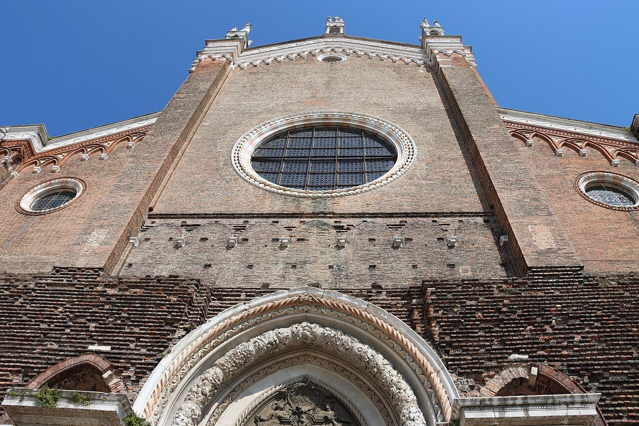 The brick front and rose window of Santi Giovanni e Paolo from below