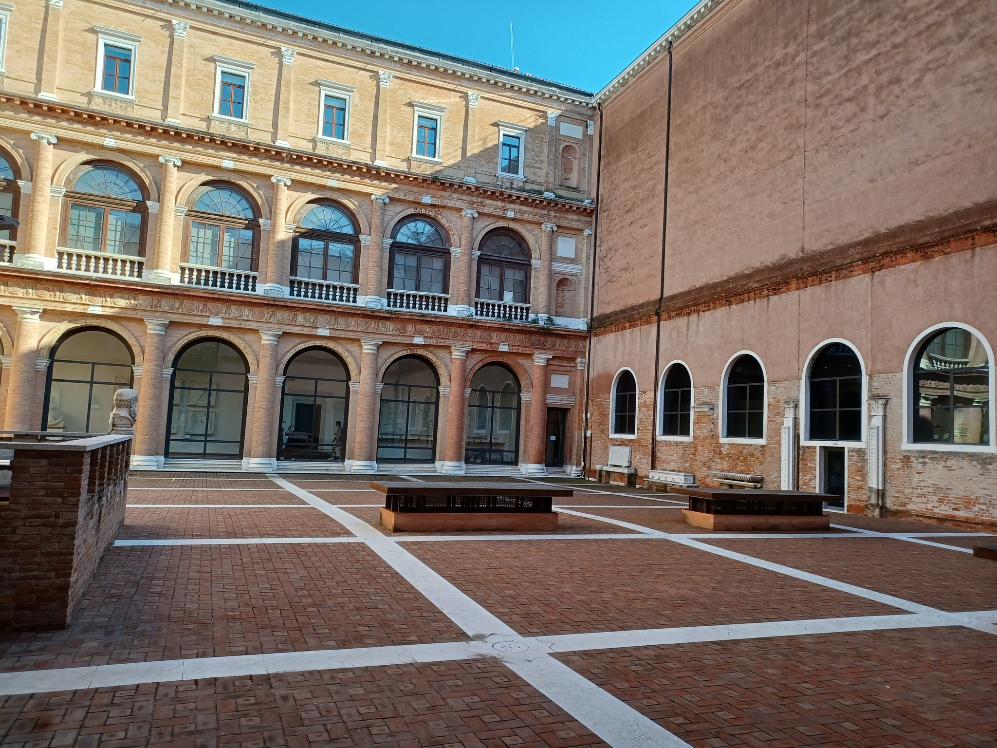 The brick courtyard of the Accademia, arcaded on two sides