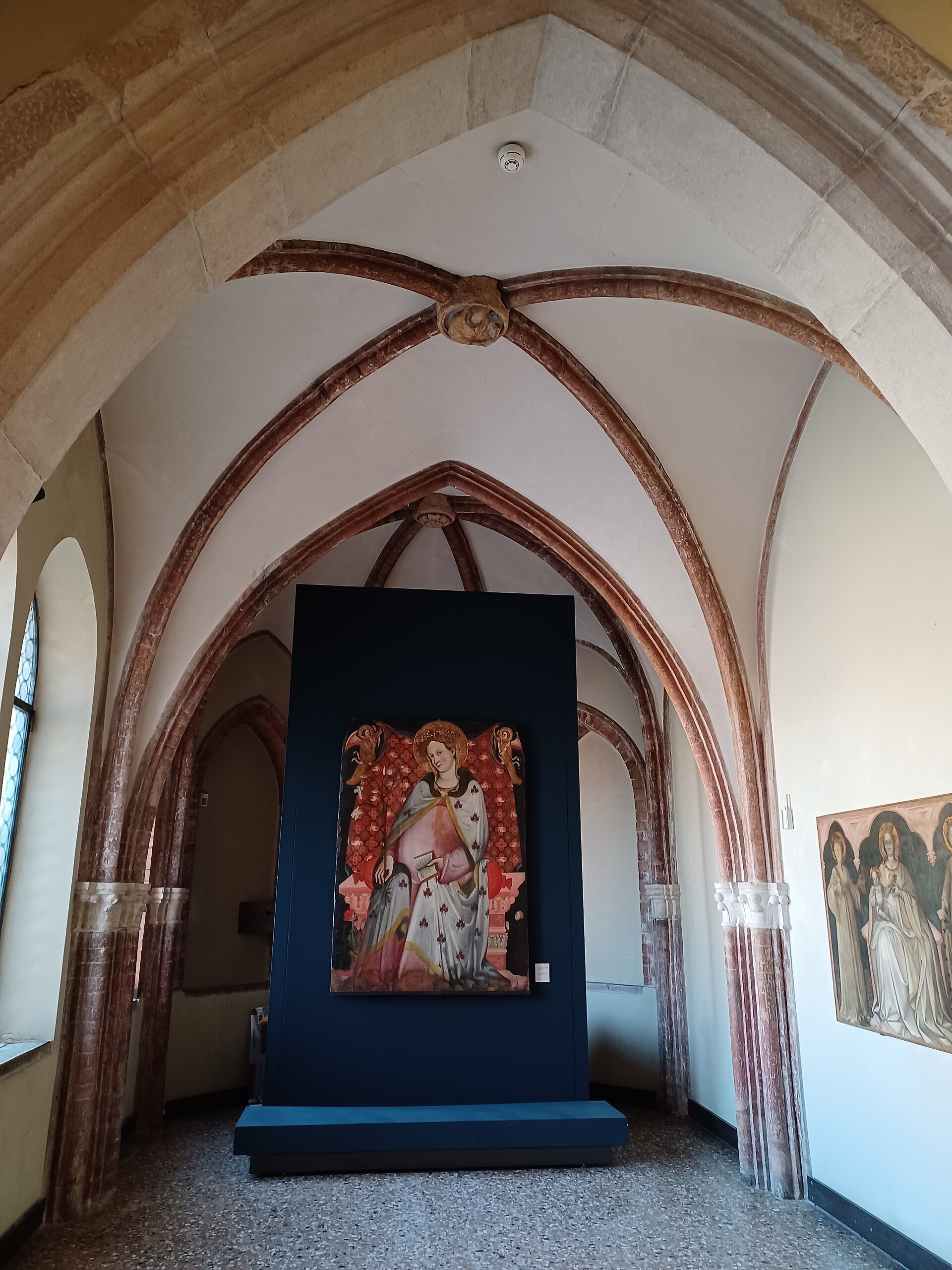 A Gothic hall in the Accademia with a large altarpiece at the far end