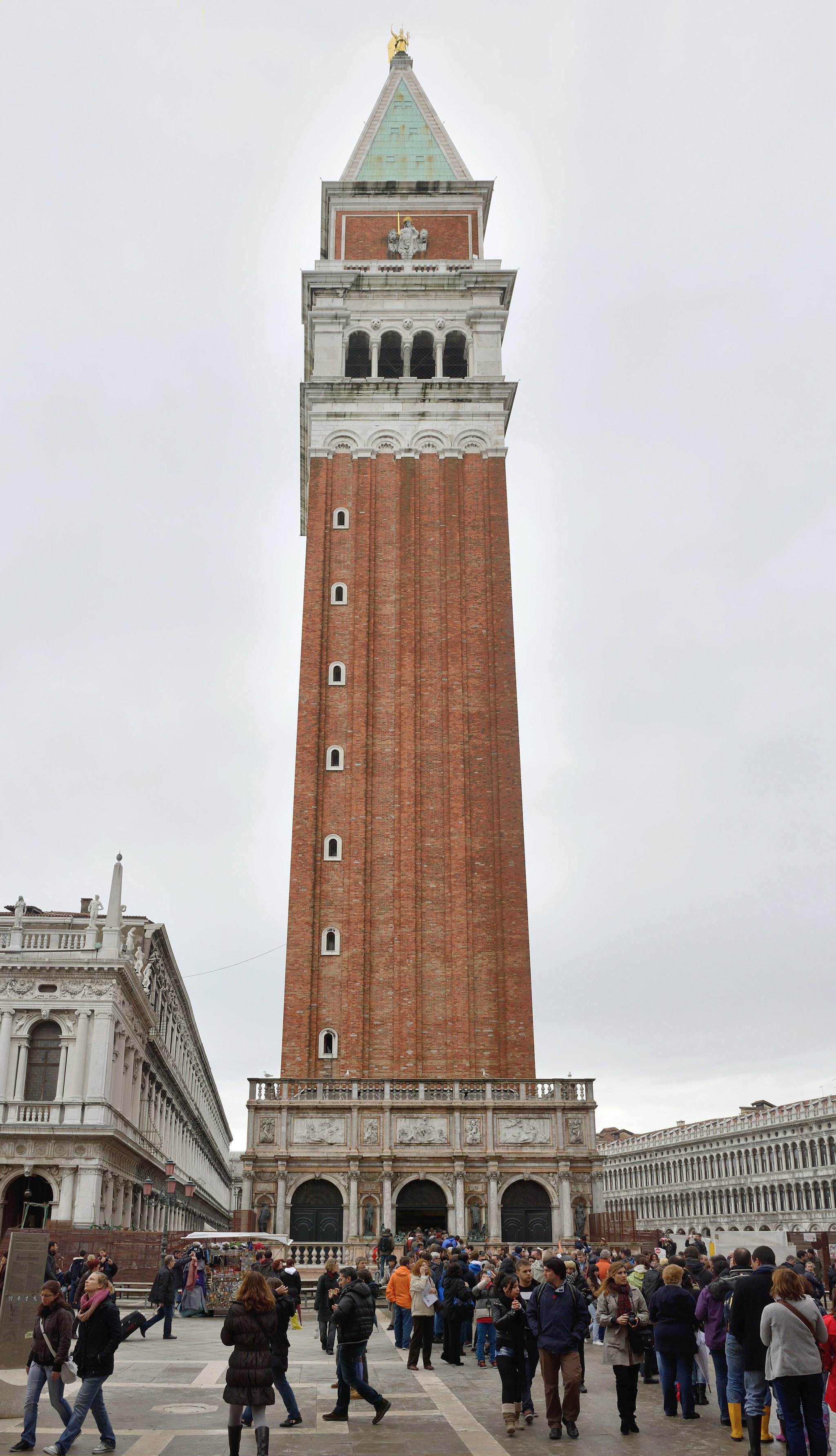 The Campanile of St Mark's rising from the corner of the square, with Sansovino's Loggetta at its foot