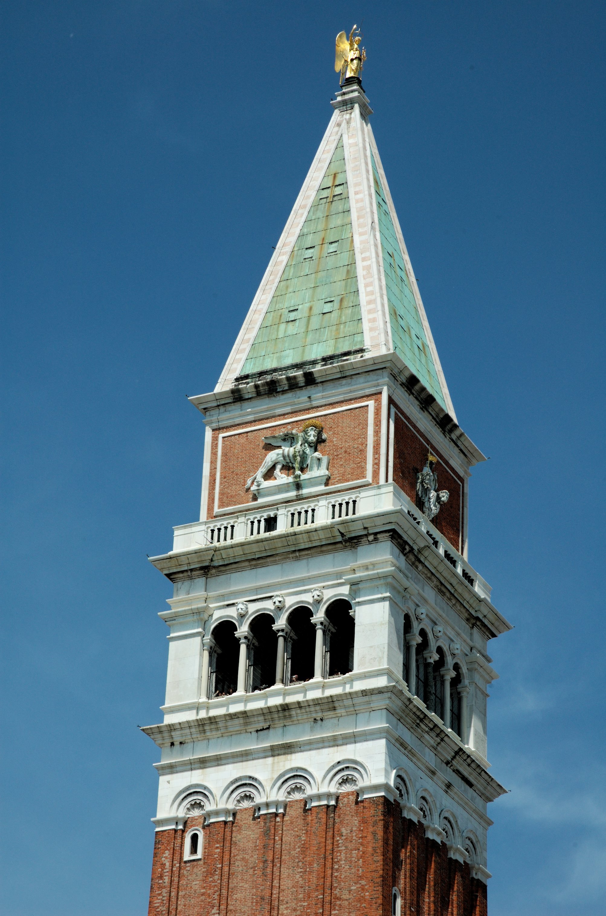 The belfry of the Campanile close to, the gold angel on the spire above the arched openings