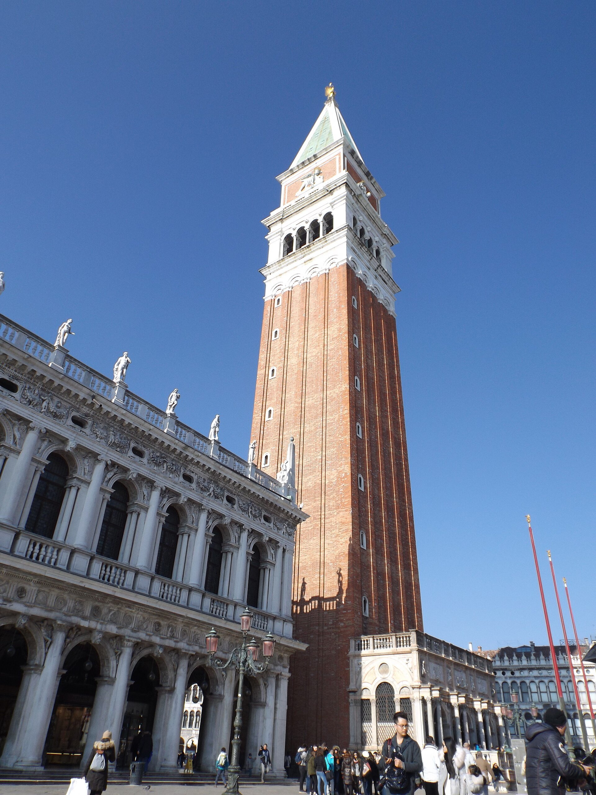 The Campanile from under the arcade of the Procuratie Nuove, the paving of the square running away