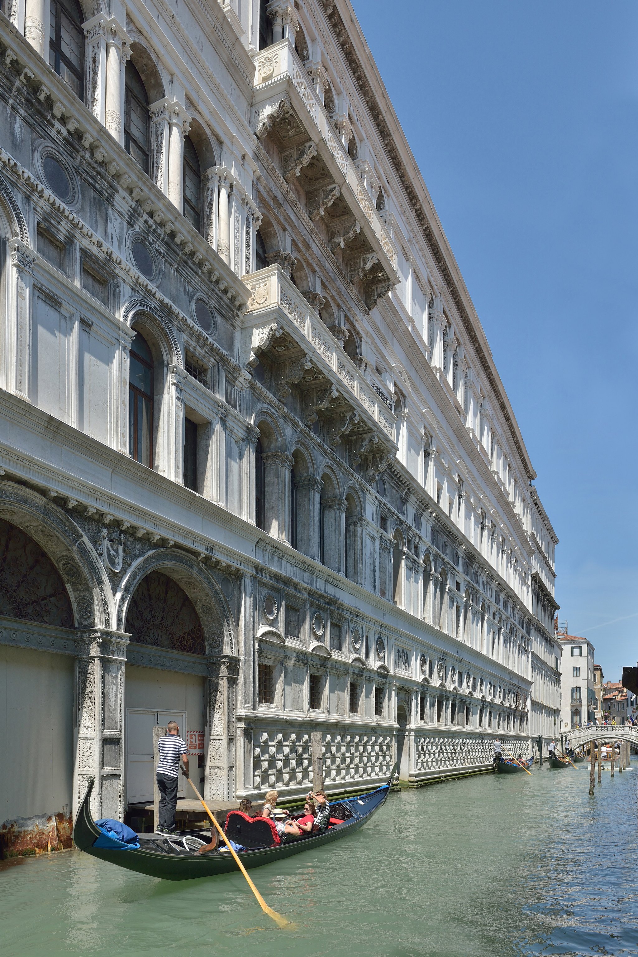 The Doge's Palace from the water, its double arcade of pointed arches carrying the pink upper wall