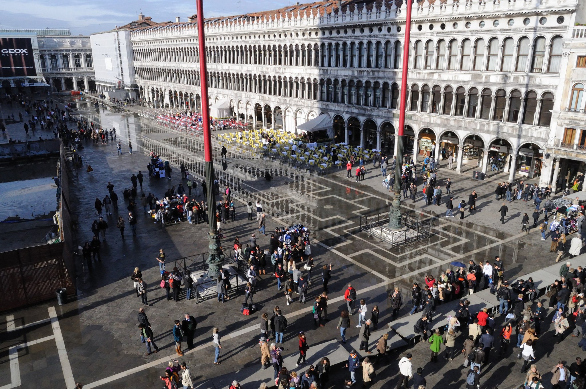Piazza San Marco from above during high water, raised walkways laid in lines across the flooded paving