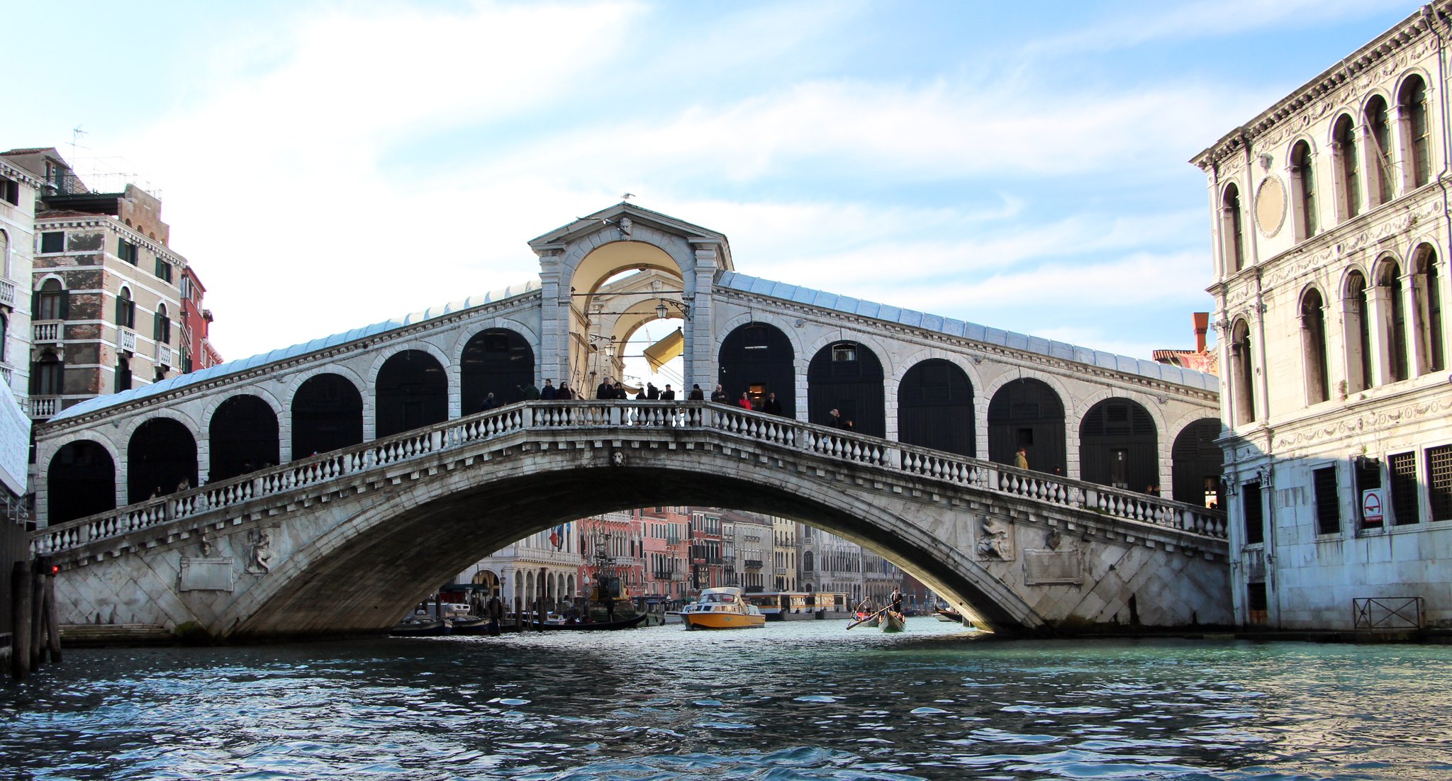 The Rialto Bridge from a boat on the Grand Canal, the single stone span filling the frame