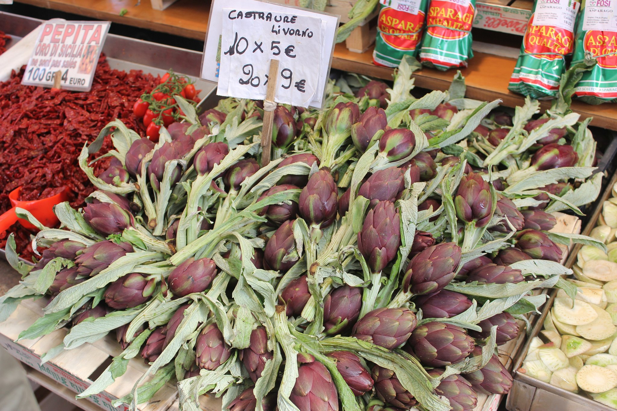 A Rialto market stall stacked with vegetables and handwritten price cards