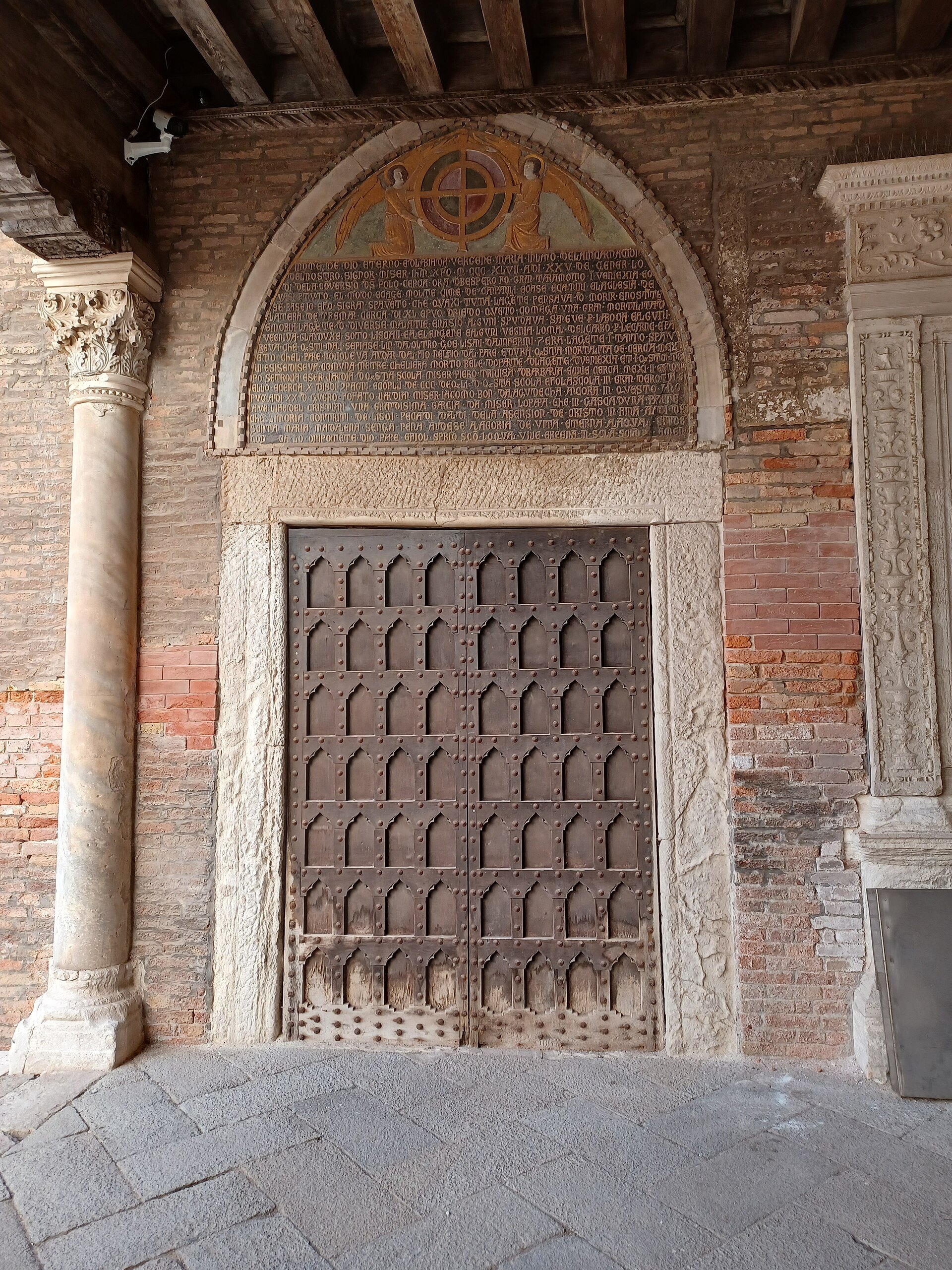 A stone doorway at the Accademia, the old monastery entrance under a pointed arch