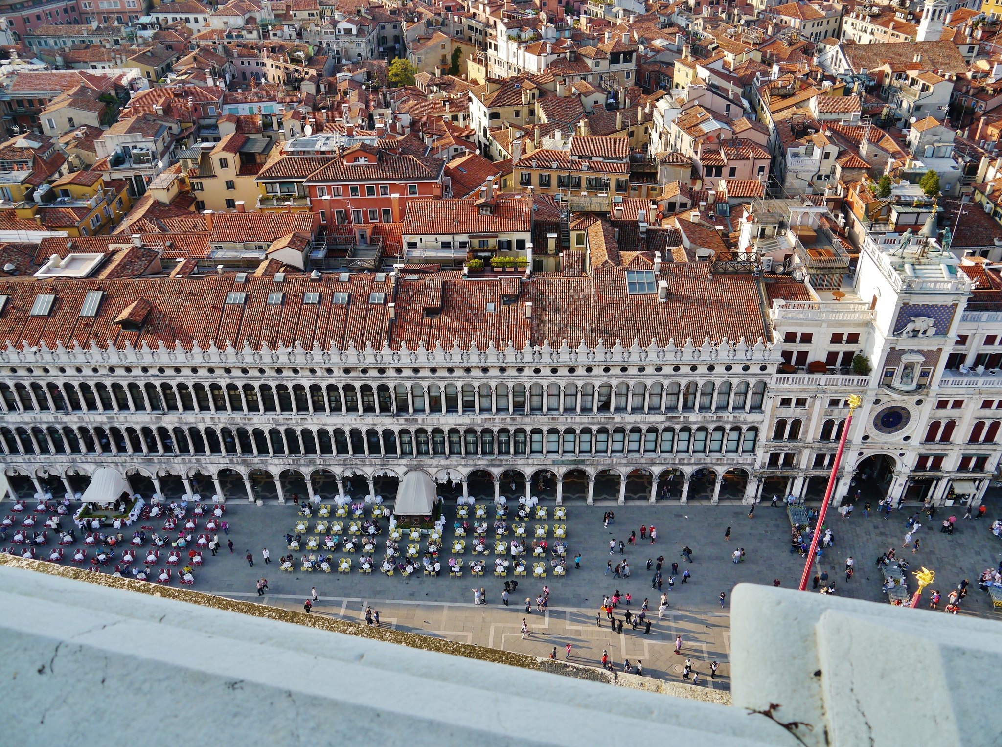 Venice from above, an unbroken field of terracotta roofs with almost no water visible between them