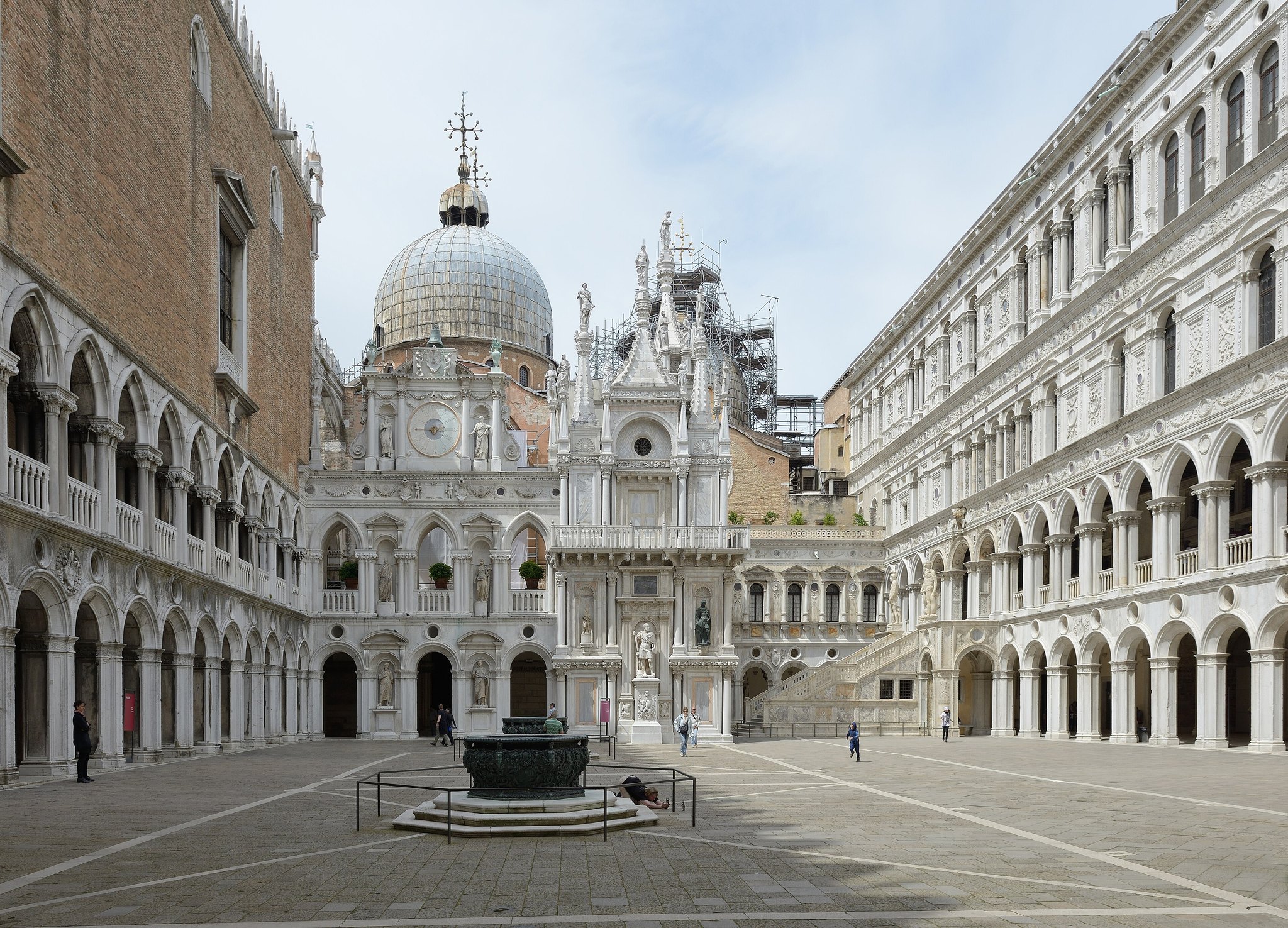 St Mark's Basilica seen across the courtyard of the Doge's Palace, its lead domes and gold mosaics above the arcade
