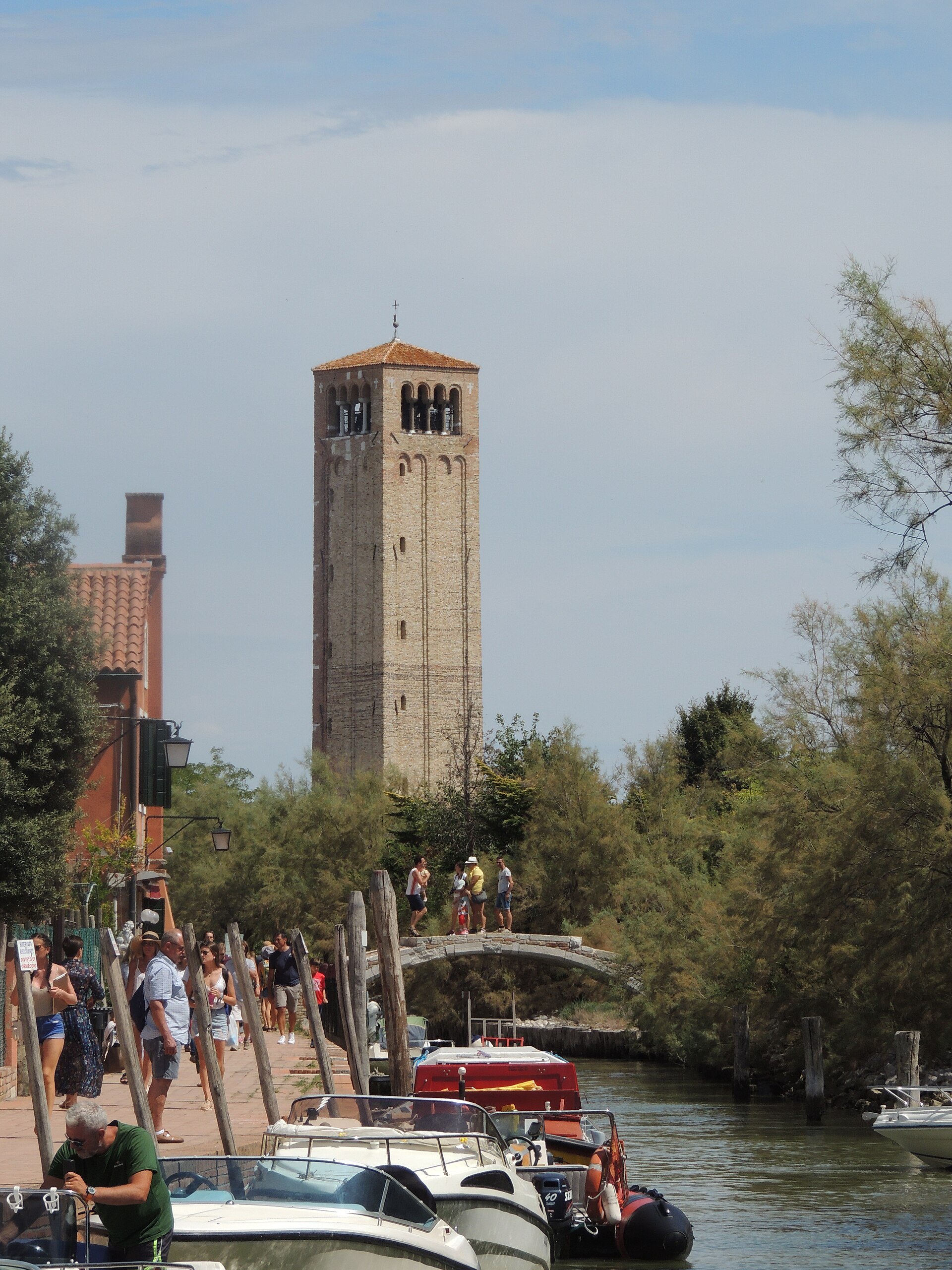The canal on Torcello with boats moored along it and the campanile beyond