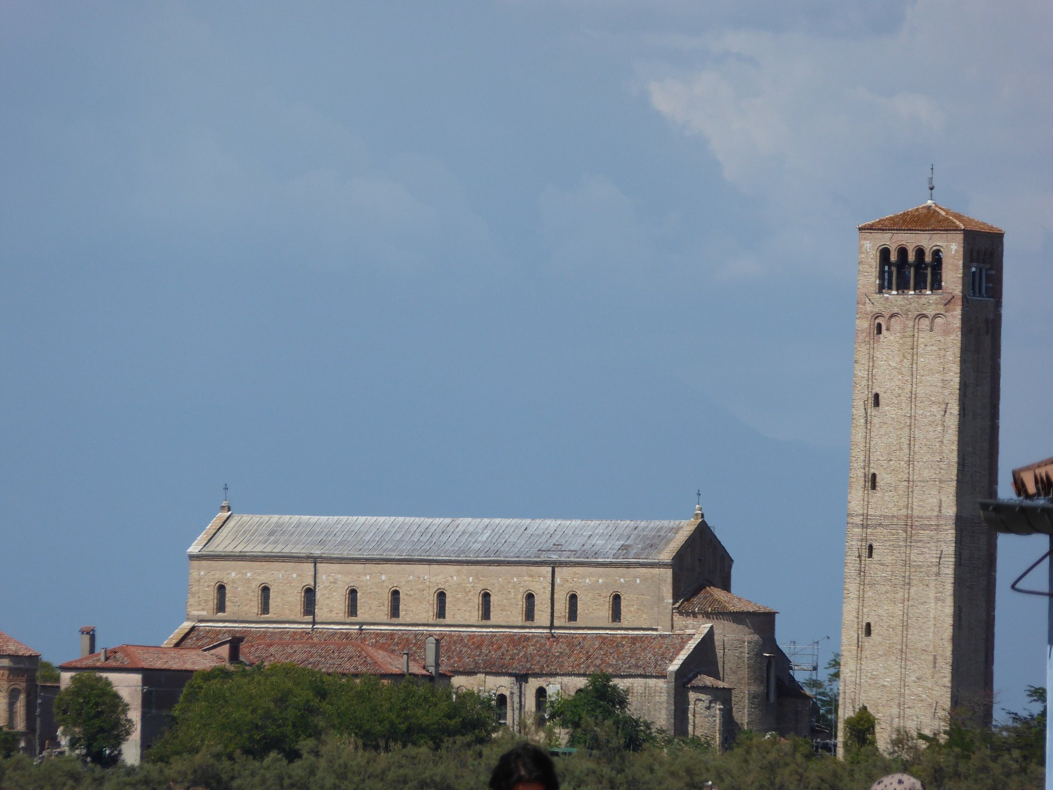 Torcello seen across the water from Burano, the basilica and its tower low on the horizon
